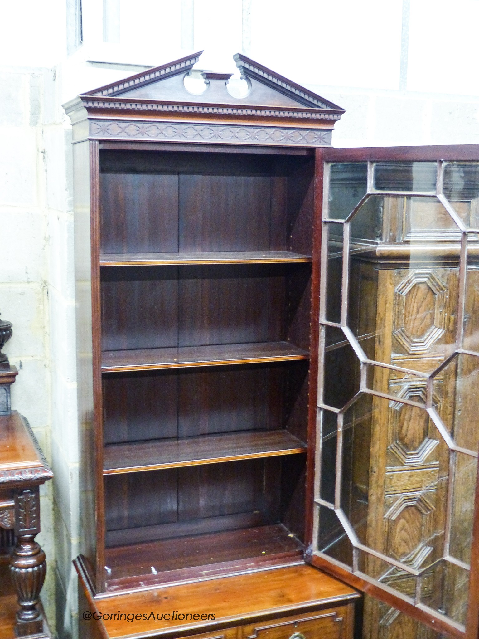 An early 20th century George III style narrow mahogany bookcase on chest, width 65cm, depth 44cm, height 218cm